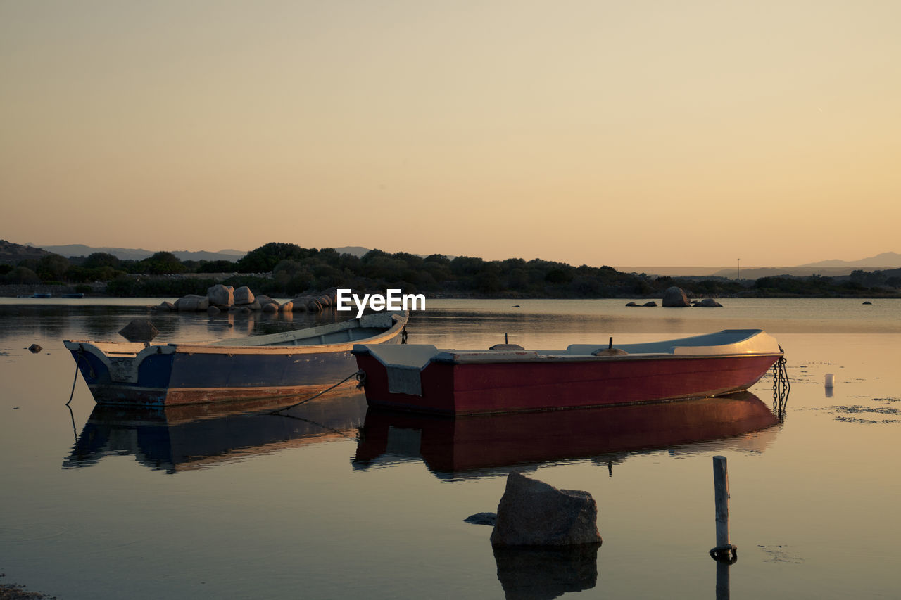 Boat moored on sea against clear sky