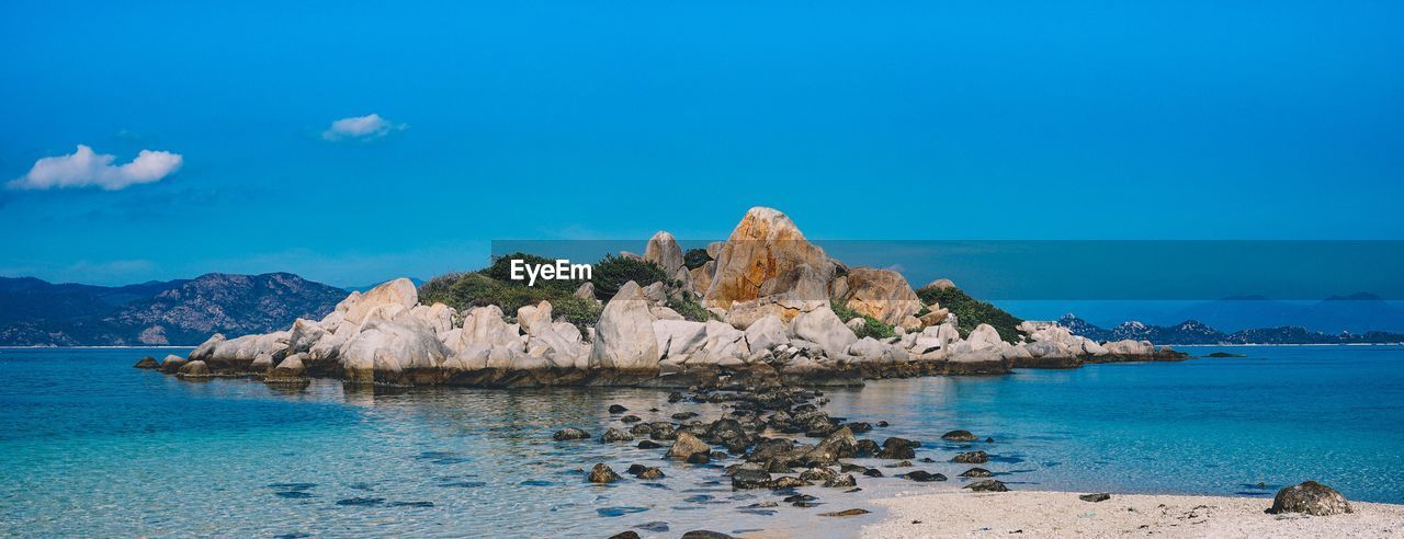 Scenic view of sea against clear blue sky