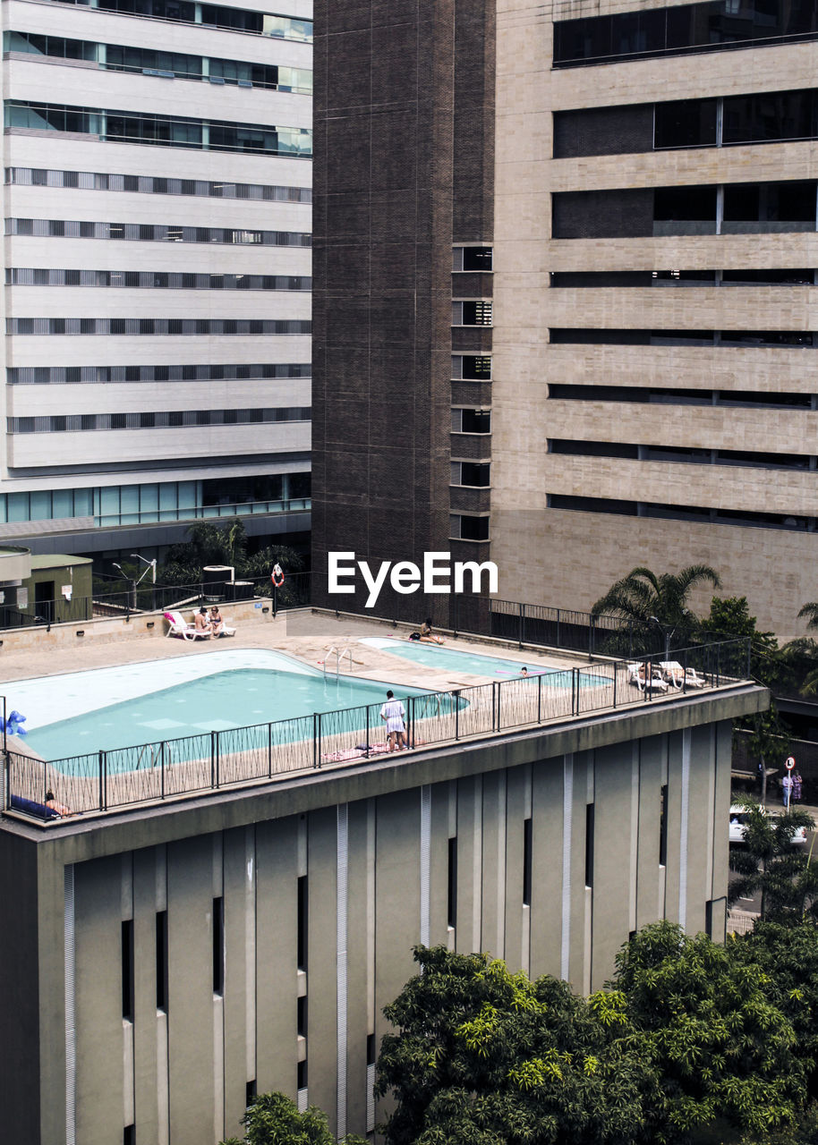 Swimming pool against building in city