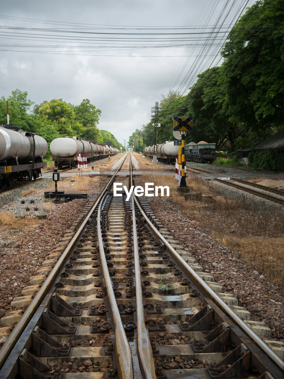 People on railroad tracks against sky