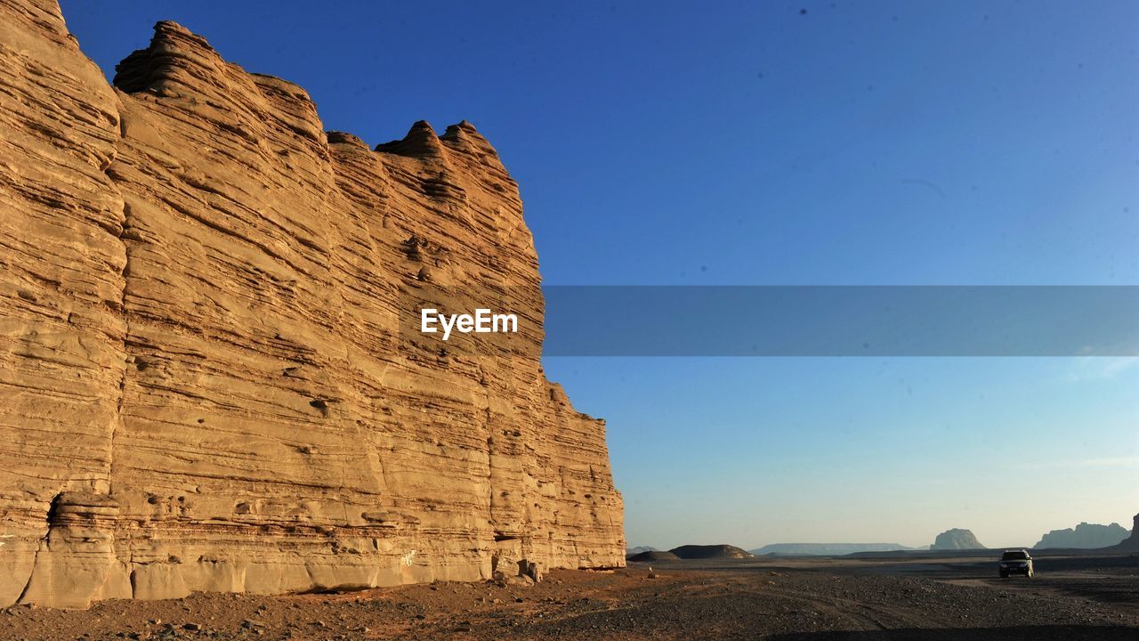 Rock formation against clear blue sky