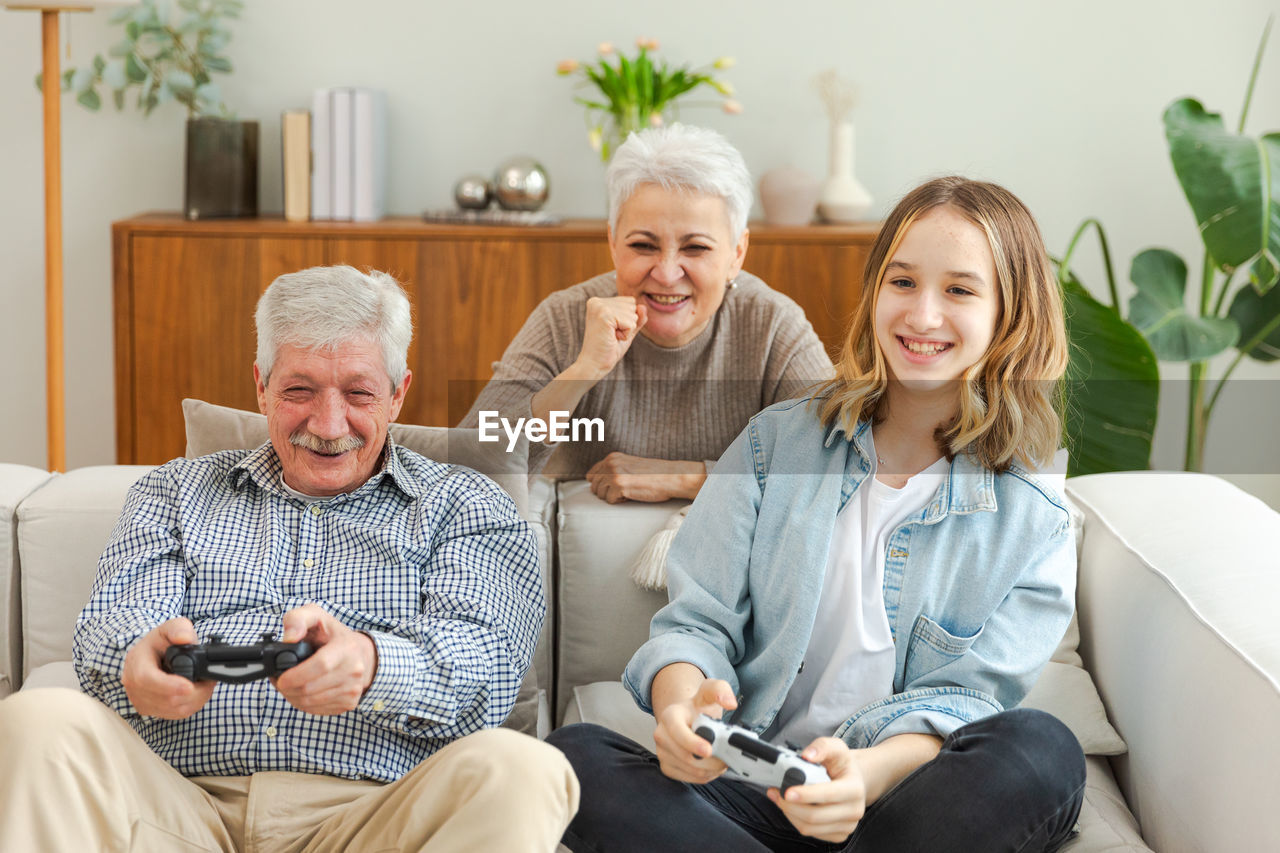 portrait of smiling family sitting at home