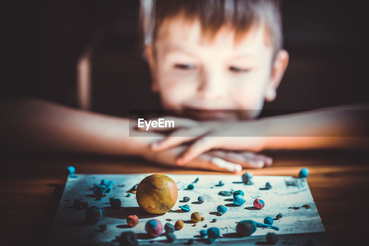 close-up of boy looking at table at home