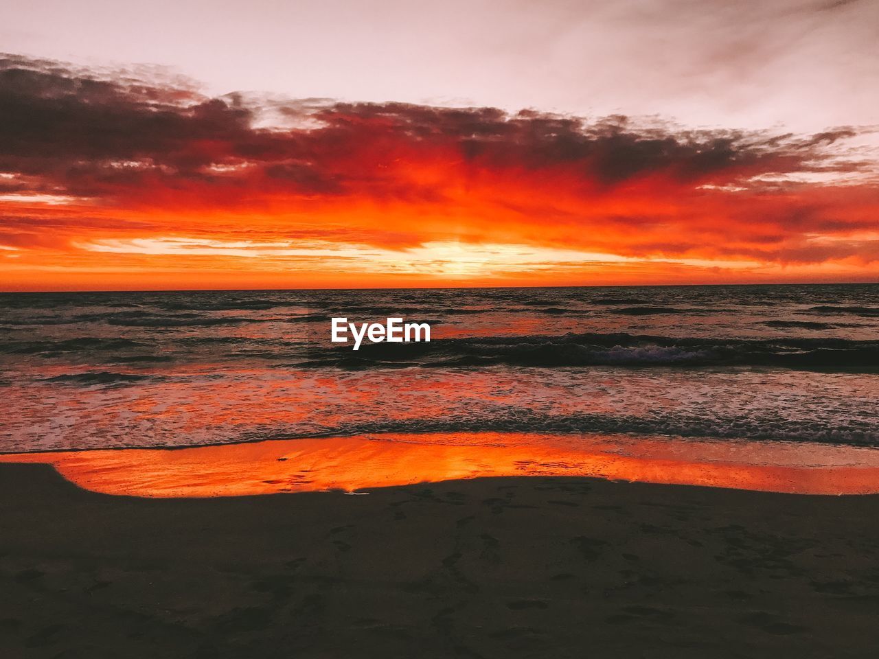 Scenic view of sea against romantic sky at sunset