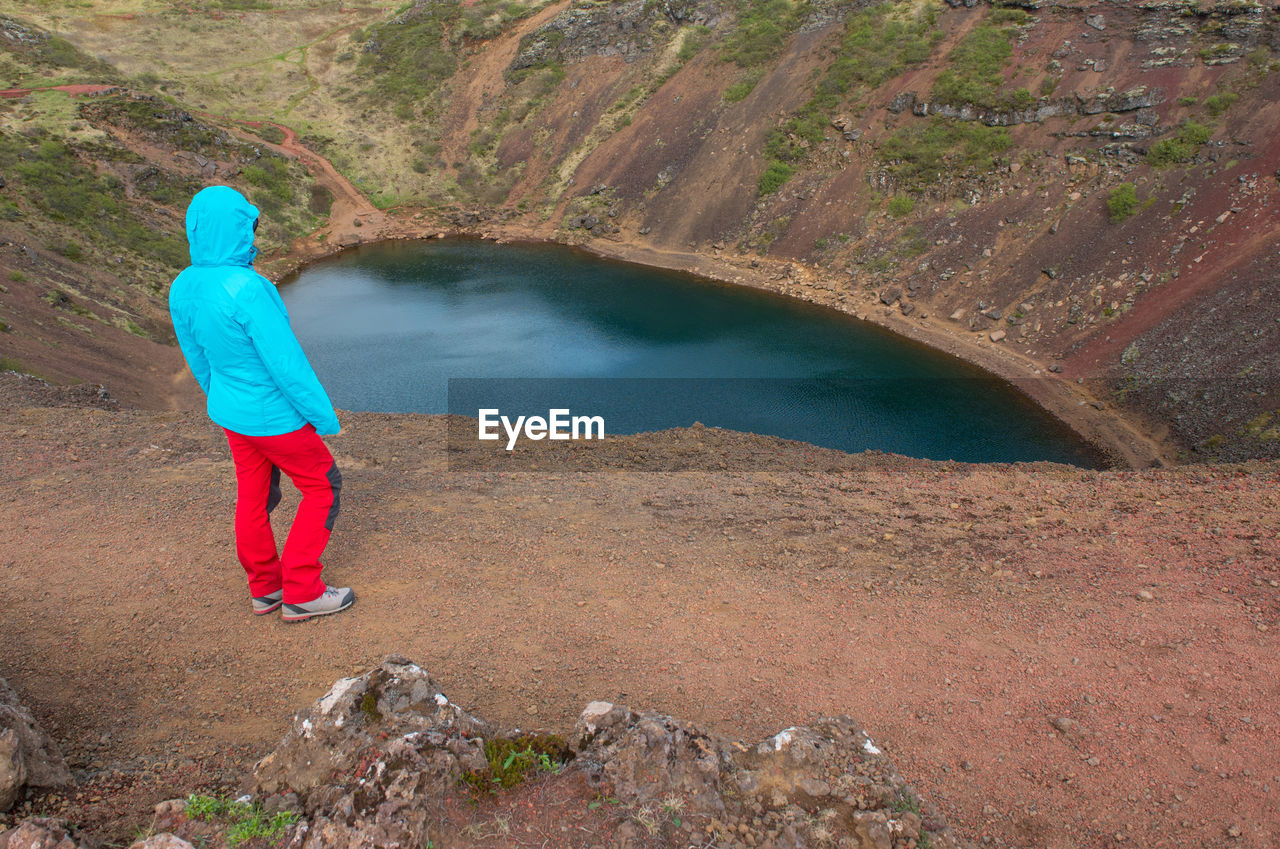 Traveler woman admiring kerid crater, iceland