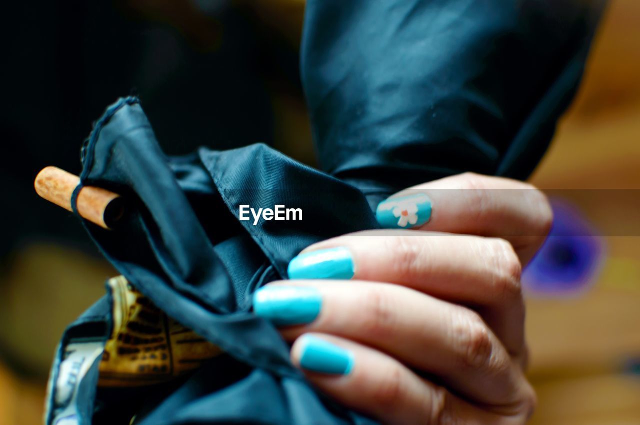 Cropped hand of woman holding fabric