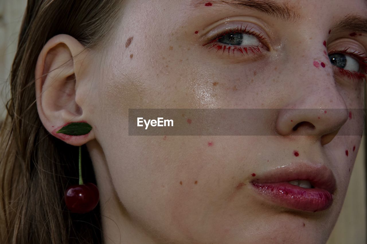 Close-up portrait of young woman with acne