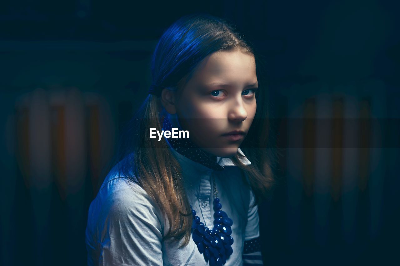 Close-up of girl in darkroom at home