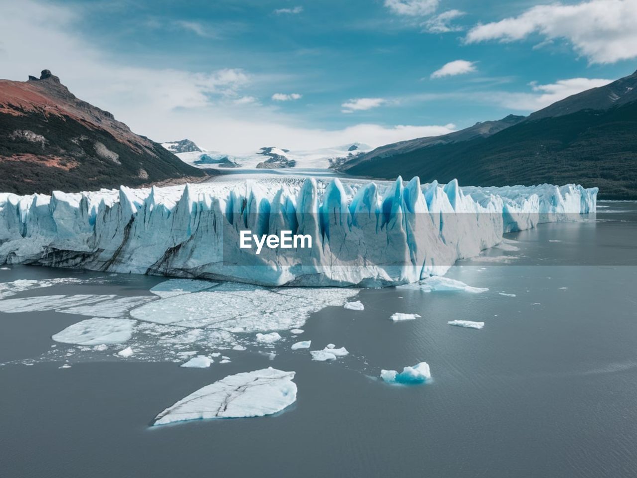 ice, cold temperature, water, landscape, environment, snow, glacier, frozen, winter, scenics - nature, beauty in nature, nature, iceberg, mountain, sky, lagoon, lake, glacial landform, travel, travel destinations, reflection, polar climate, floating, sea ice, social issues, cloud, blue, glacial lake, land, ice cap, floating on water, tranquil scene, tranquility, wilderness, extreme terrain, environmental issues, no people, non-urban scene, climate change, tourism, polar ice cap, outdoors, melting, mountain range, remote