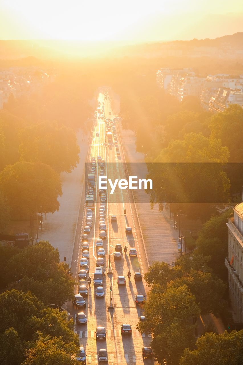 High angle view of vehicles on road at sunset