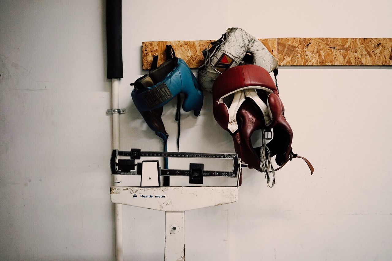 Boxing head protectors mounted on wall at home