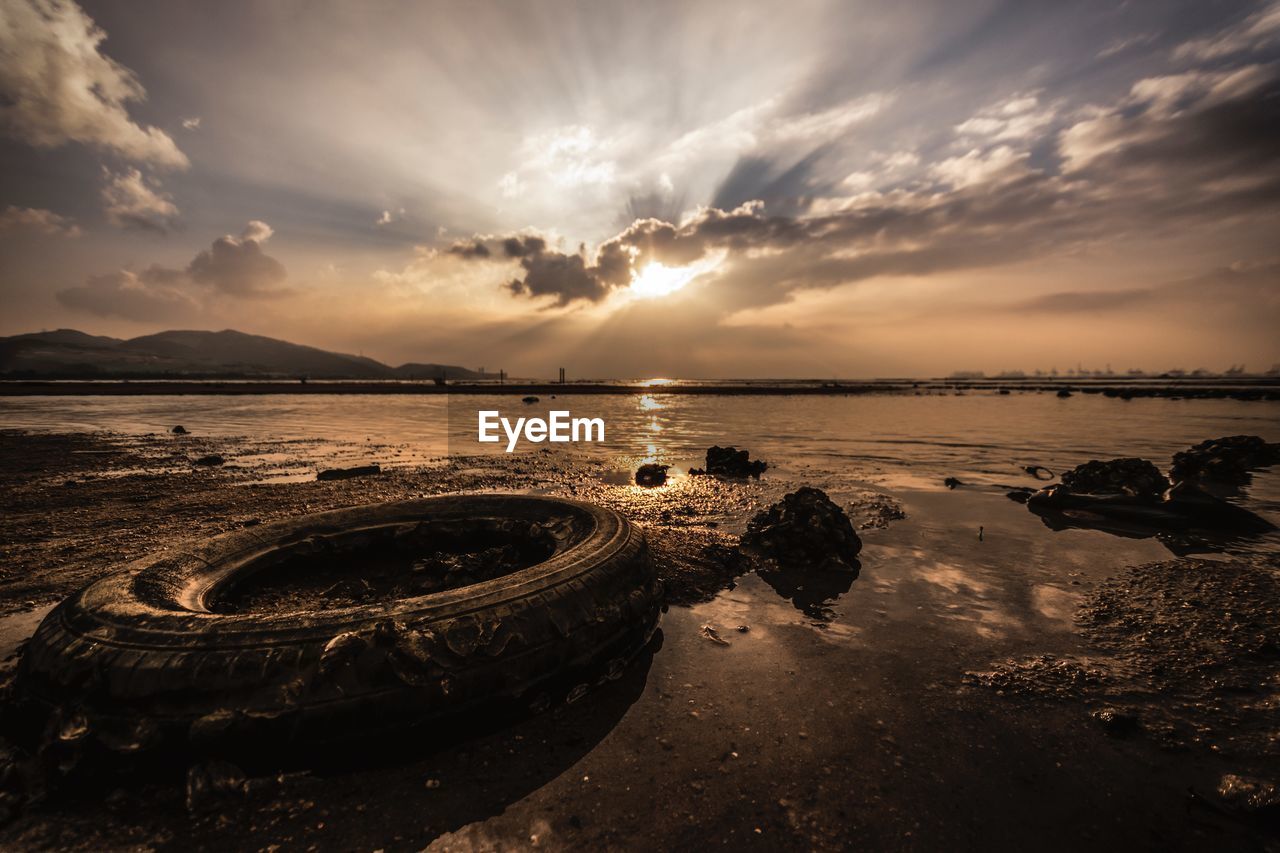 SCENIC VIEW OF BEACH AGAINST SKY DURING SUNSET