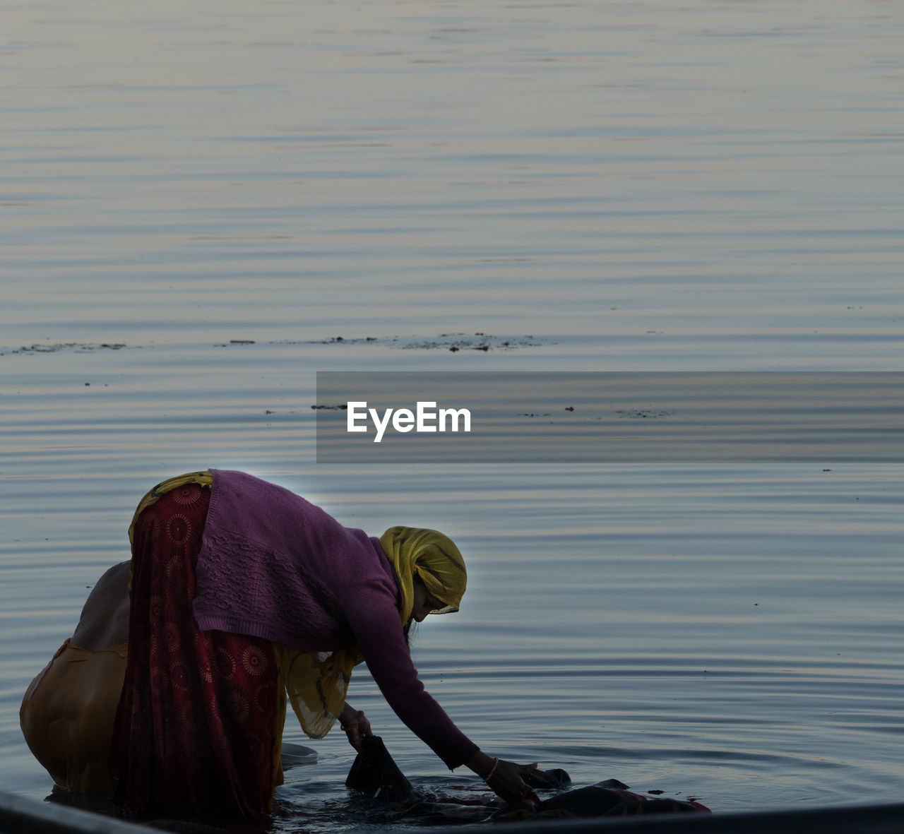 Side view of woman standing on shore