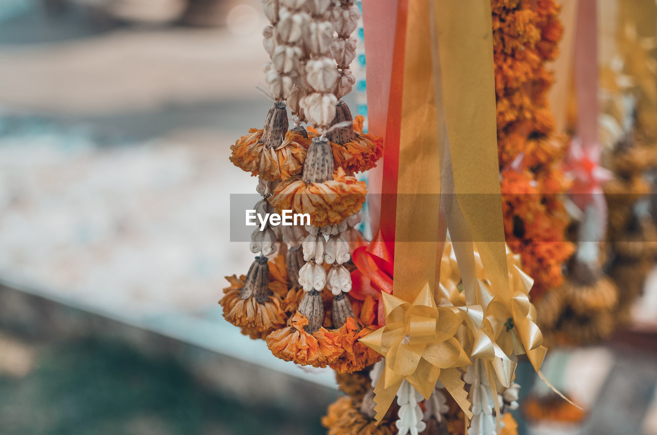 CLOSE-UP OF CROSS HANGING ON CLOTHESLINE