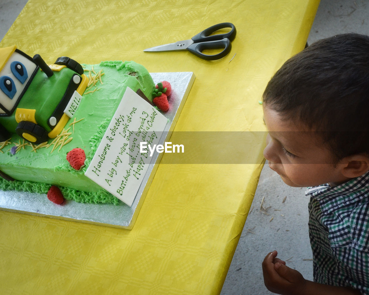 Close-up of boy looking at birthday cake