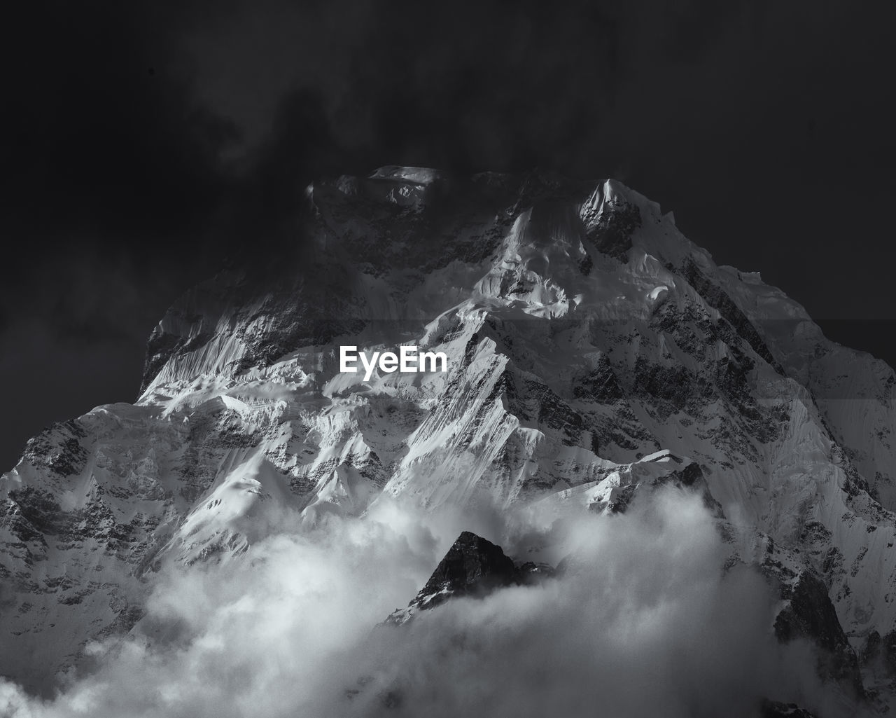 Aerial view of snowcapped mountains against sky