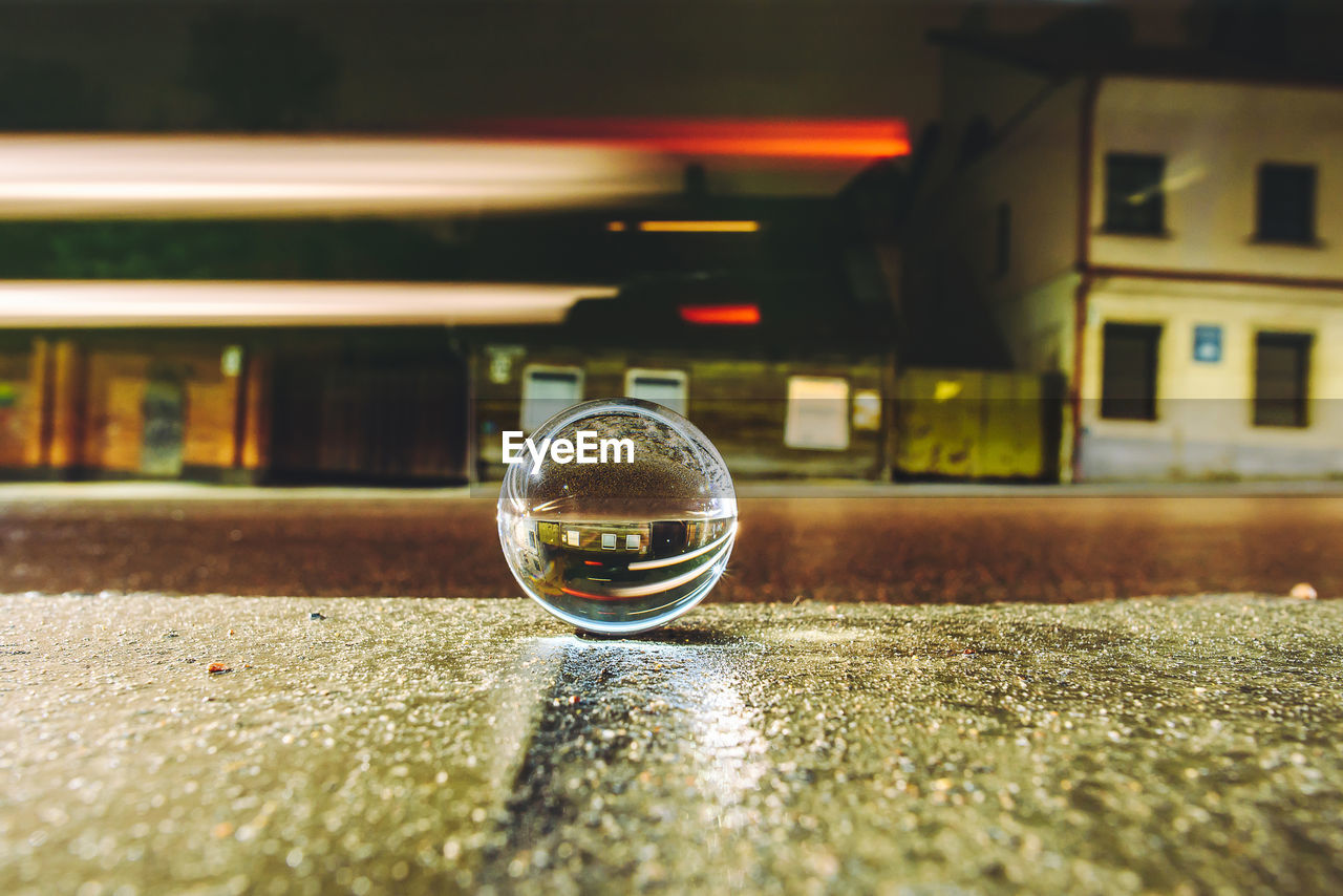 Close up of crystal ball on city street at night