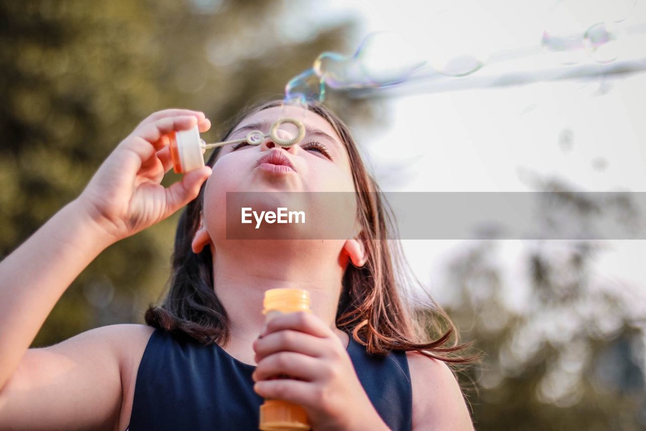 PORTRAIT OF WOMAN HOLDING ICE CREAM IN DRINKING WATER