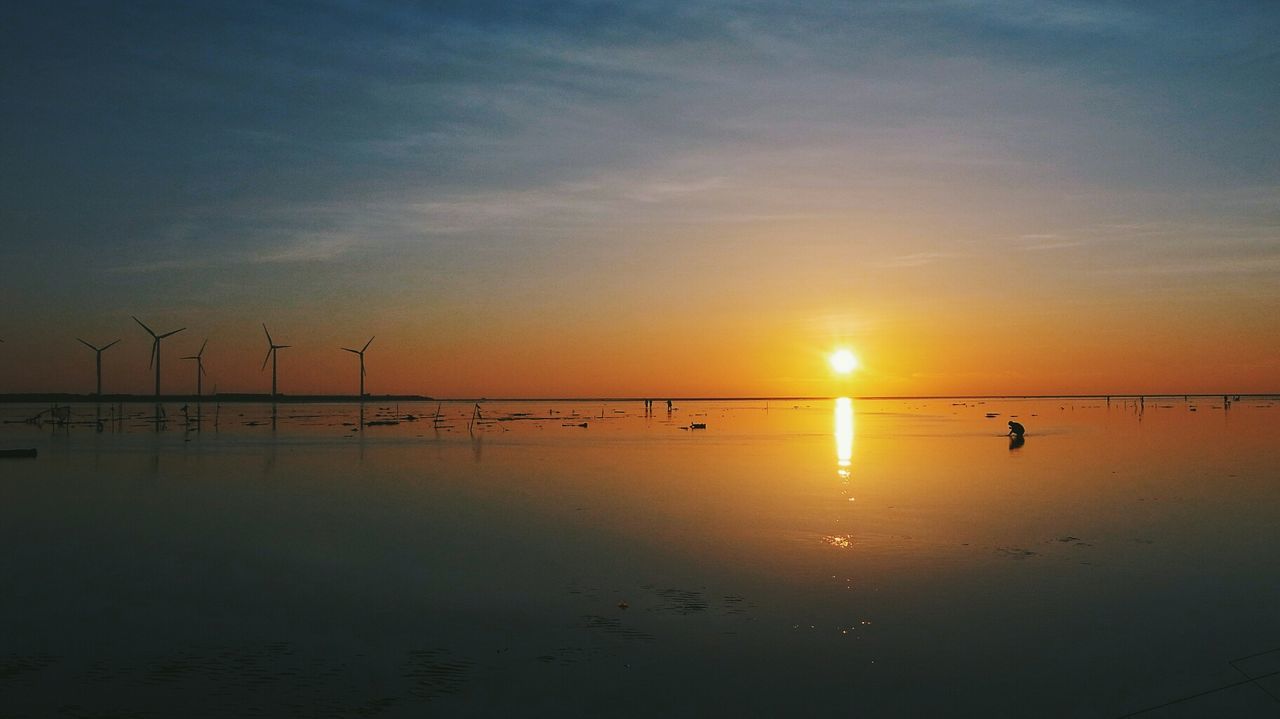 View of calm scenic sea at sunset