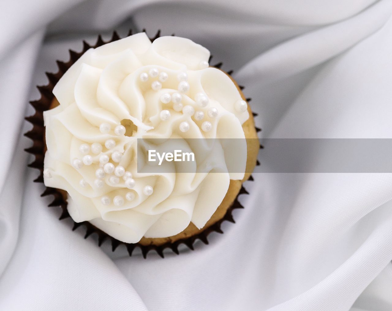 CLOSE-UP OF CUPCAKES ON WHITE