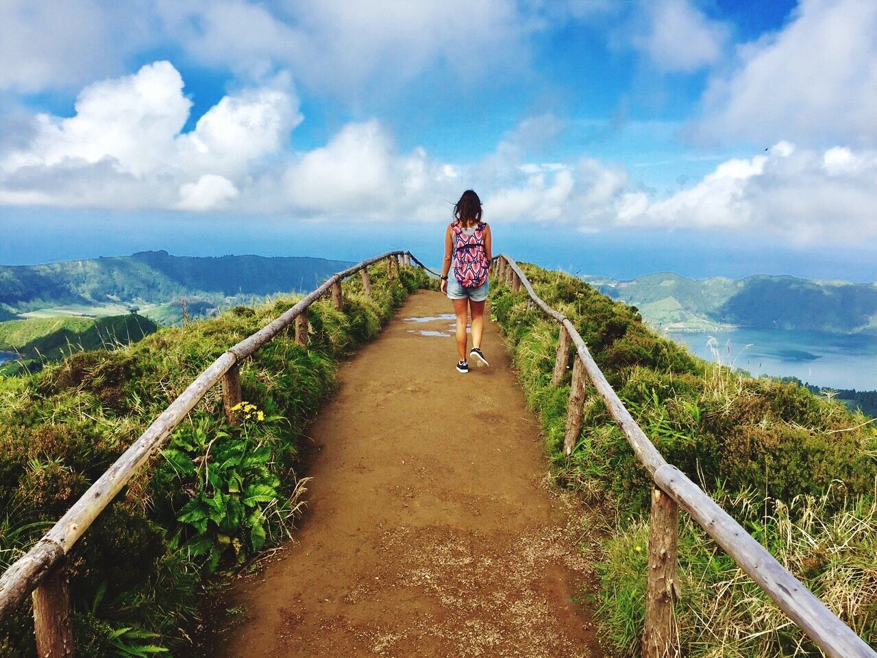 REAR VIEW OF WOMAN AGAINST MOUNTAIN