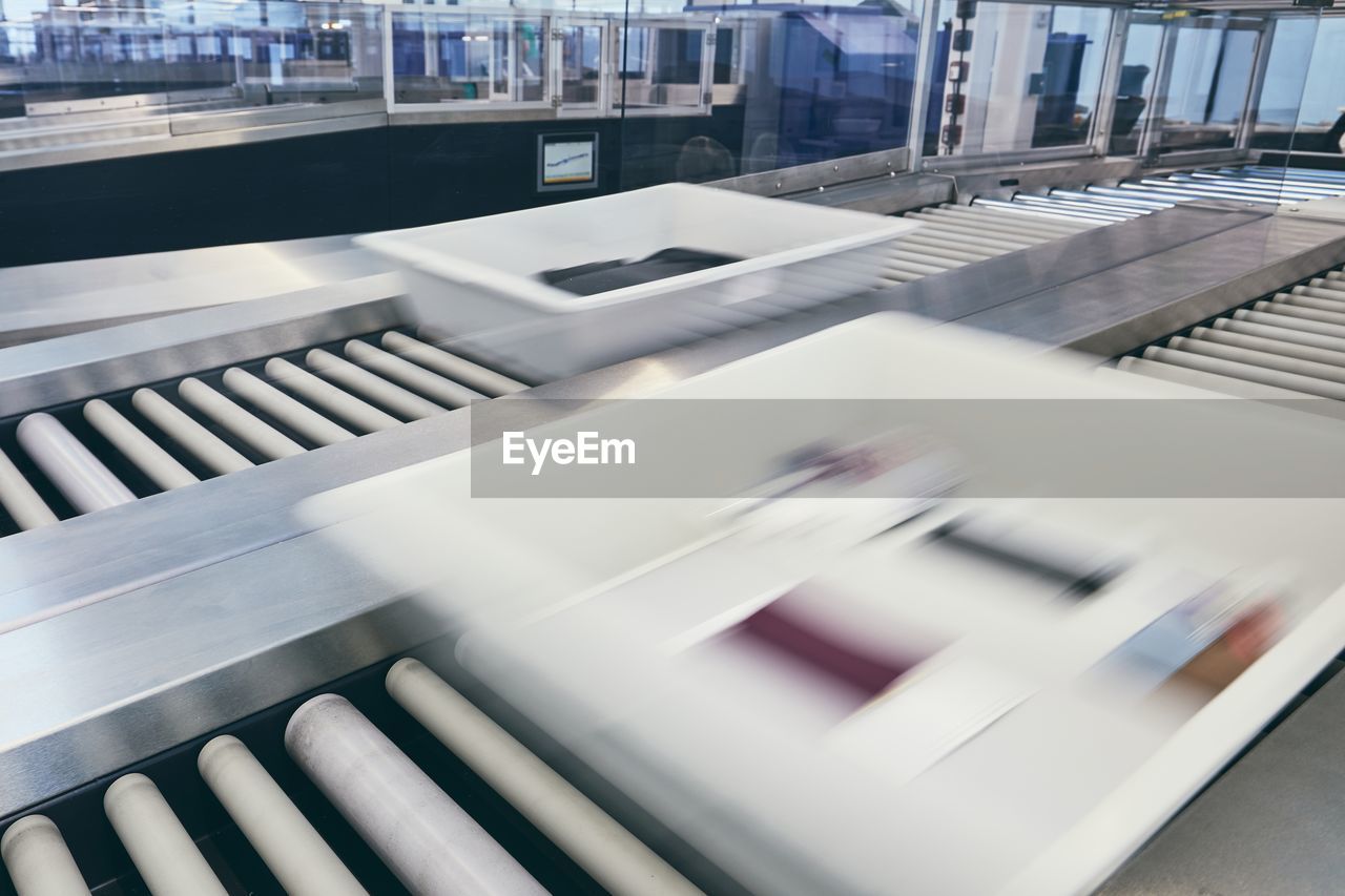 Blurred motion of box on conveyor belt at airport