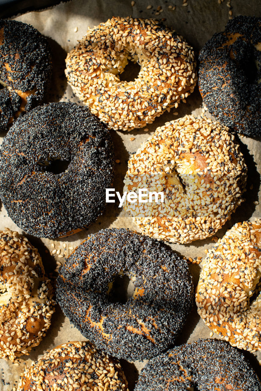 Freshly baked sesame and poppy seeded bagels. close up.