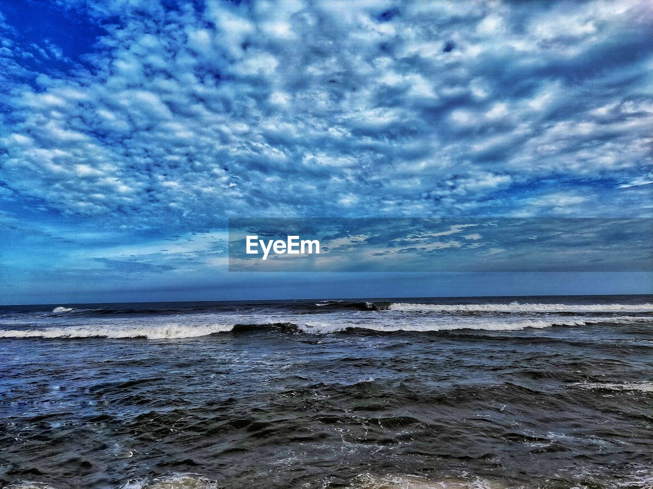 SCENIC VIEW OF BEACH AGAINST BLUE SKY