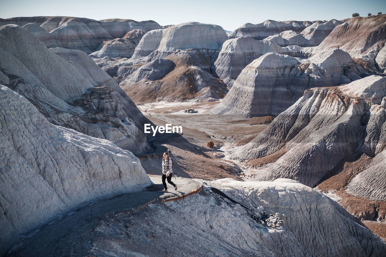 High angle view of woman hiking on mountain