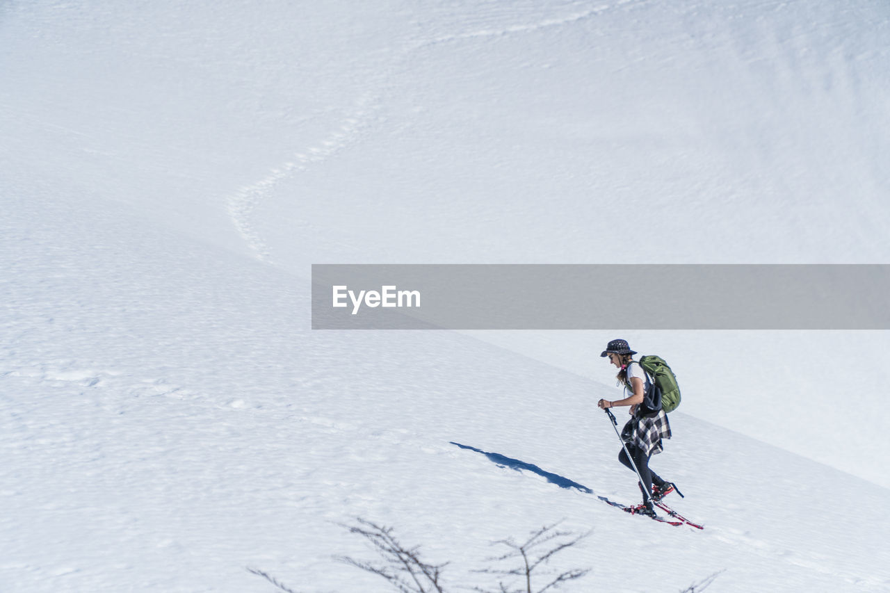 Full length of woman skiing on snow