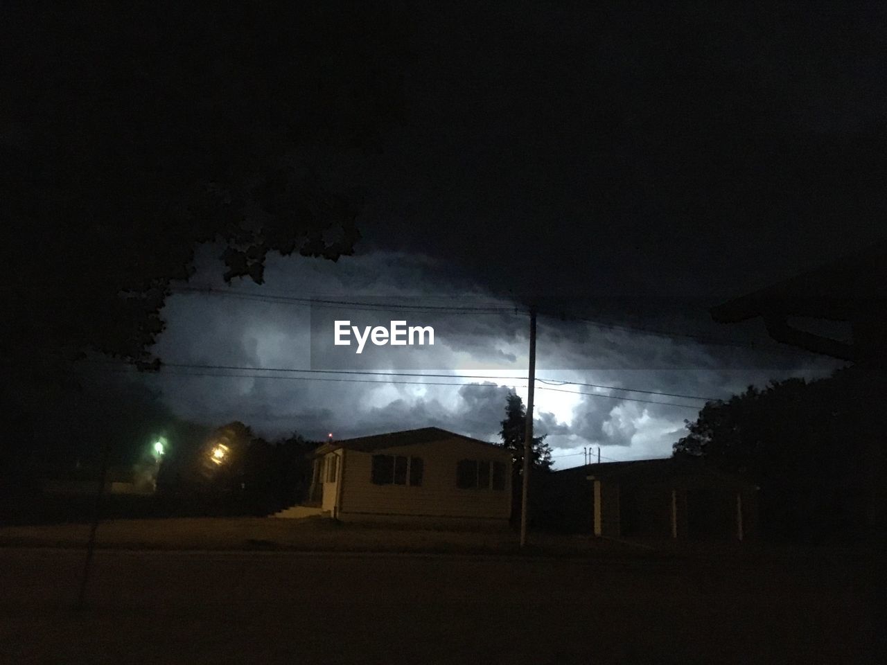 LOW ANGLE VIEW OF HOUSES AGAINST SKY AT NIGHT