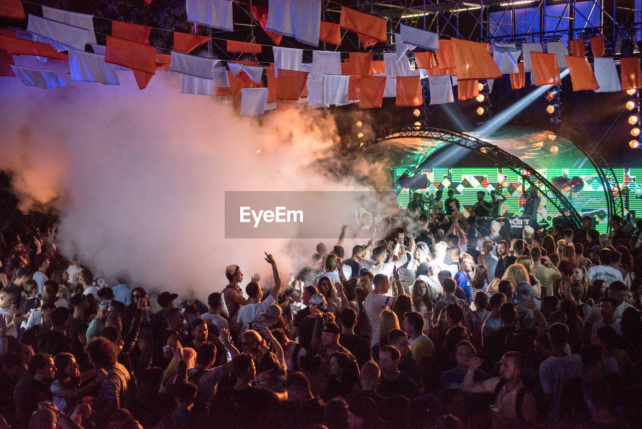 People enjoying music concert at night