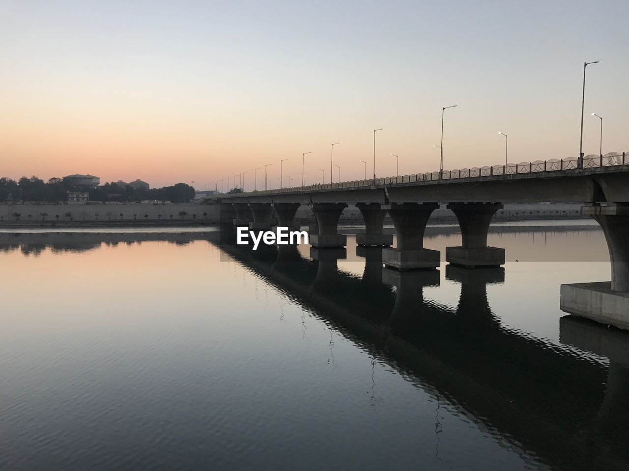 BRIDGE OVER WATER AGAINST CLEAR SKY