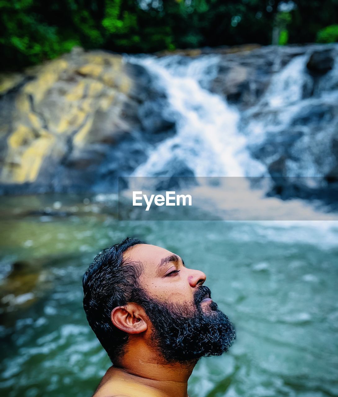water, waterfall, one person, headshot, nature, portrait, young adult, adult, men, beauty in nature, motion, river, leisure activity, beard, outdoors, rock, facial hair, lifestyles, flowing water, swimming, human face, day, relaxation, scenics - nature, sports, vacation, trip, environment, forest, holiday, wet, side view, enjoyment, looking up, person, looking, focus on foreground, land