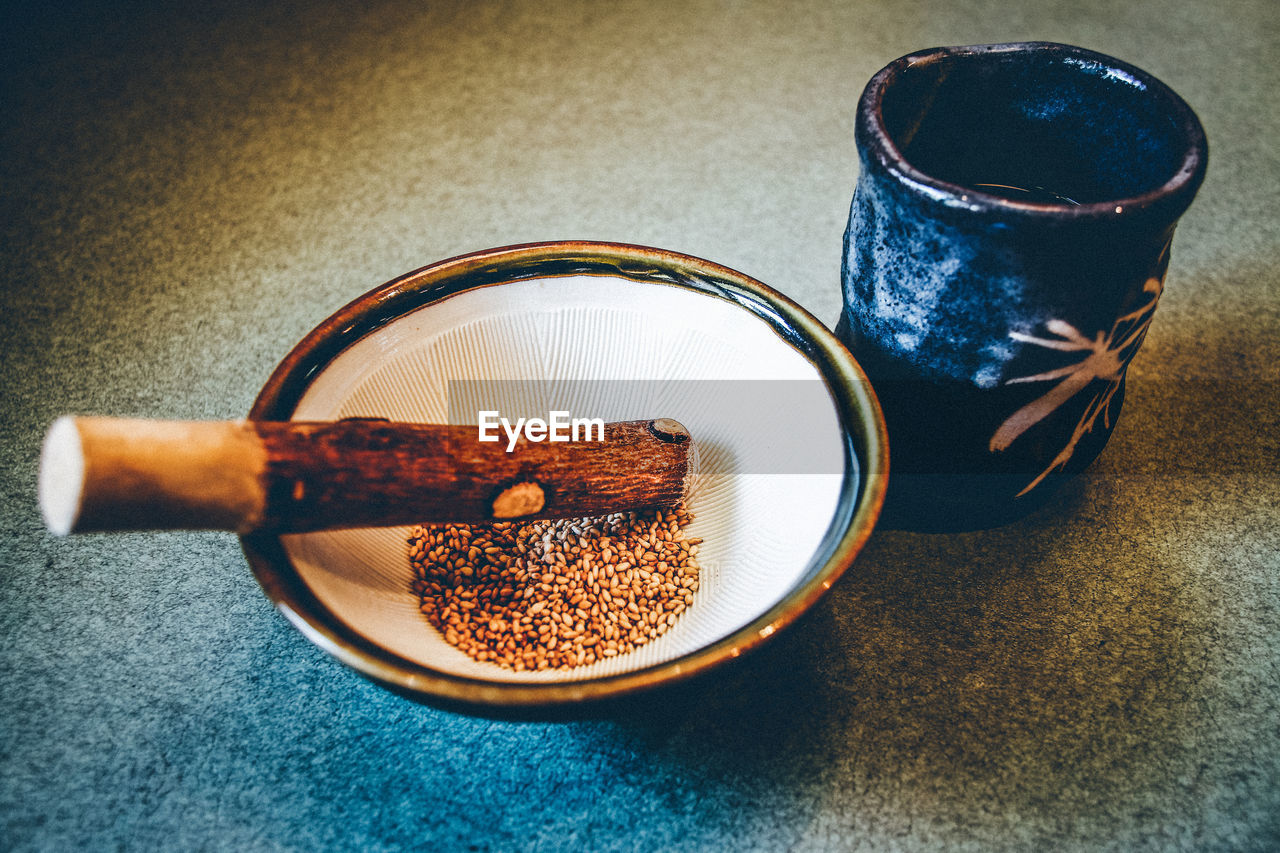 CLOSE-UP HIGH ANGLE VIEW OF DRINK ON TABLE WITH SPOON