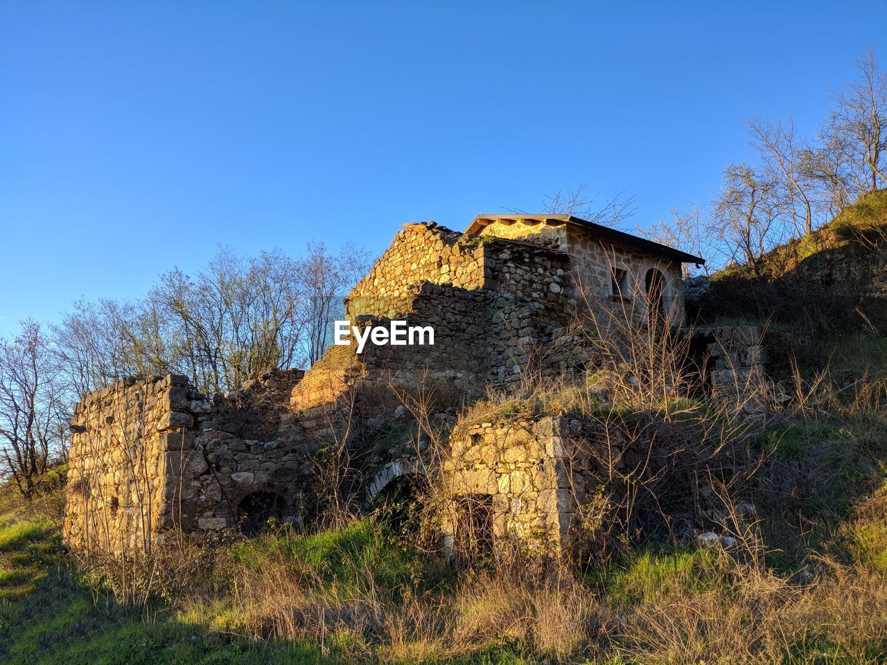 OLD BUILDING AGAINST CLEAR BLUE SKY