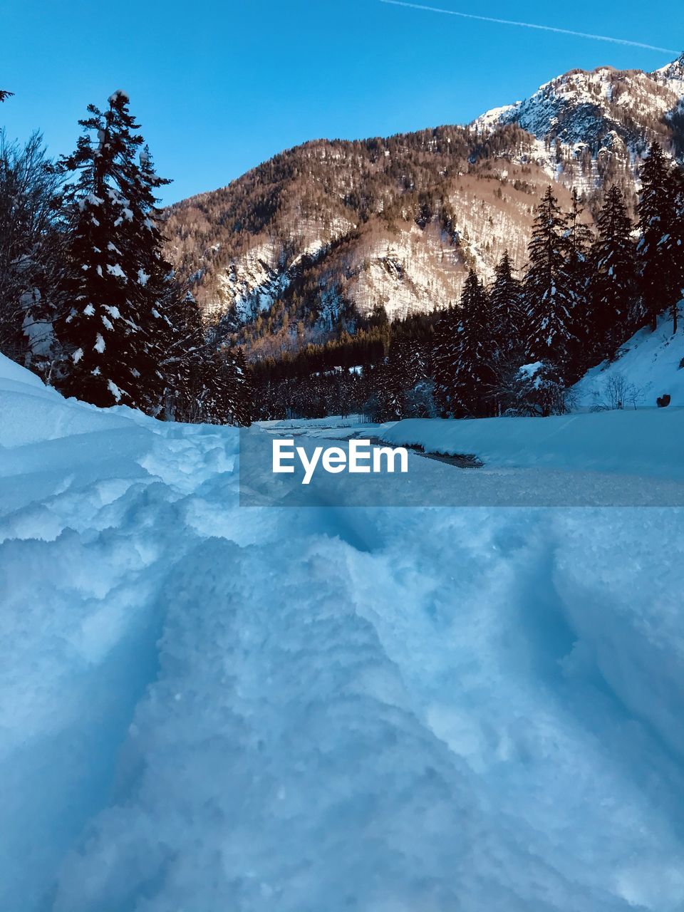 Snow covered mountain against blue sky