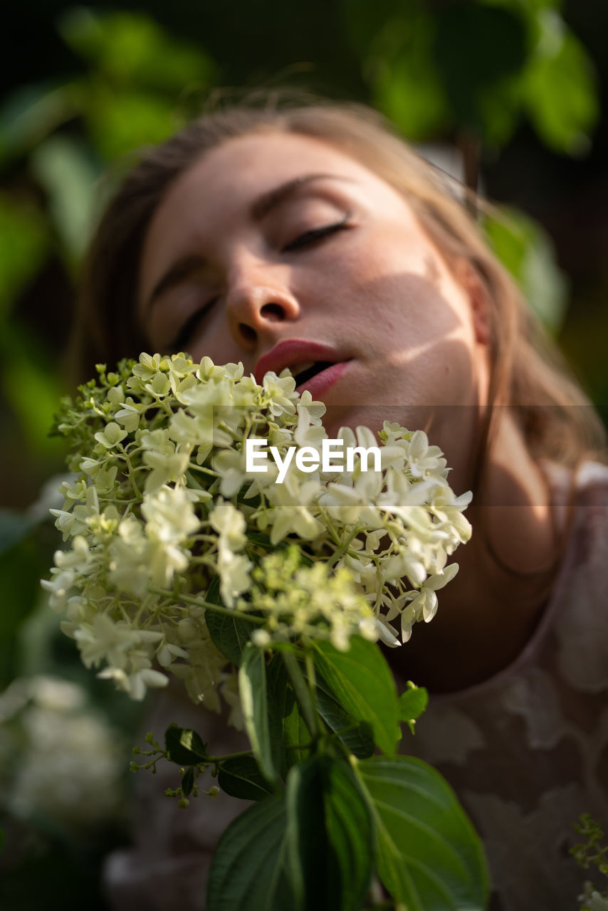 plant, flower, one person, women, adult, flowering plant, nature, young adult, bride, portrait, female, green, beauty in nature, eyes closed, freshness, emotion, headshot, holding, brown hair, outdoors, leaf, lifestyles, plant part, hairstyle, flower arrangement, smelling, happiness, long hair, bouquet, food, close-up, spring, positive emotion, looking, summer