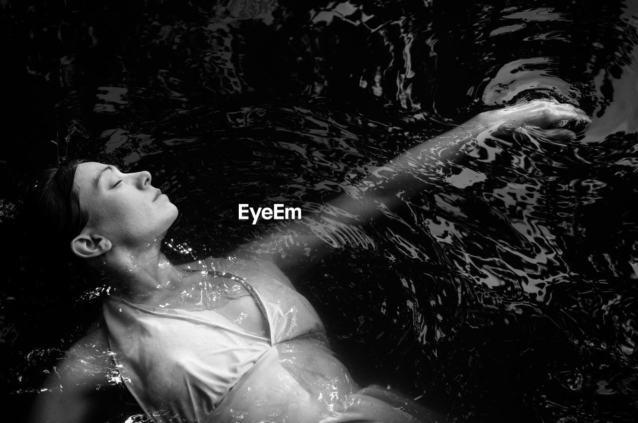 High angle view of woman swimming in lake