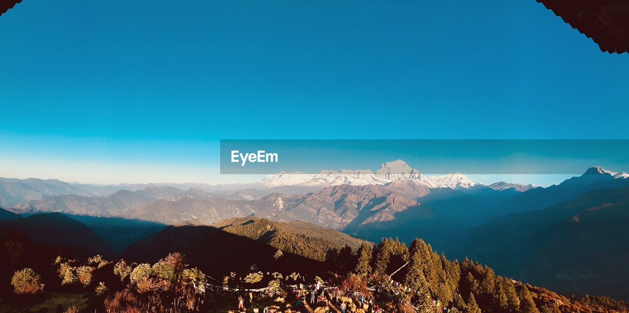 View of mountain range against blue sky