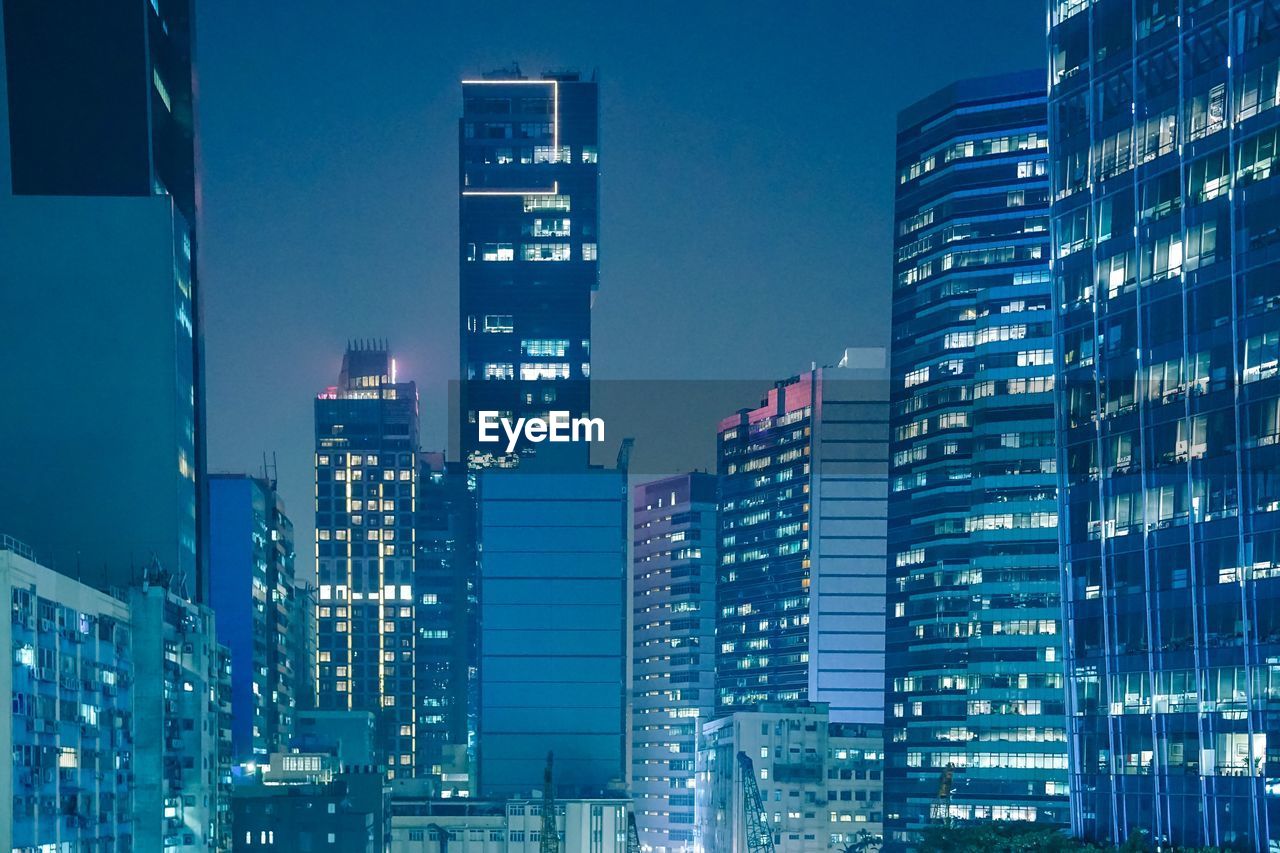 ILLUMINATED BUILDINGS AGAINST SKY AT NIGHT