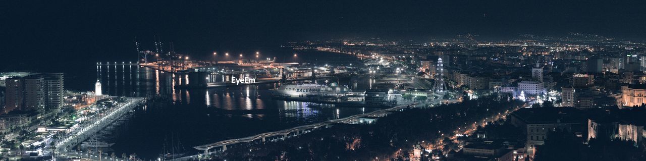 HIGH ANGLE VIEW OF ILLUMINATED BUILDINGS AT NIGHT