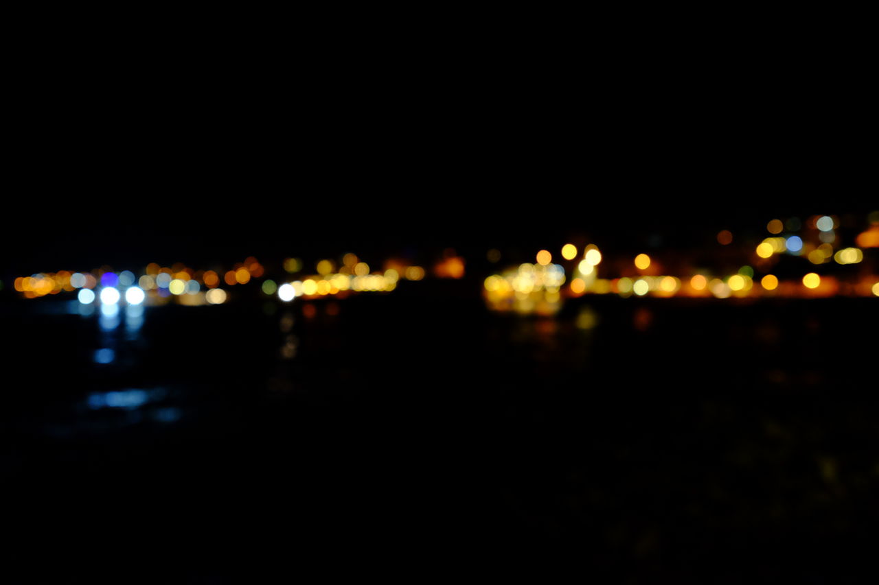 Defocused image of illuminated city at night