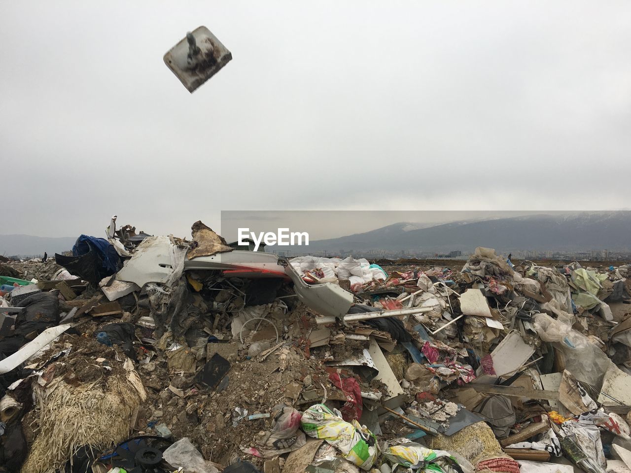 STACK OF GARBAGE AGAINST SKY