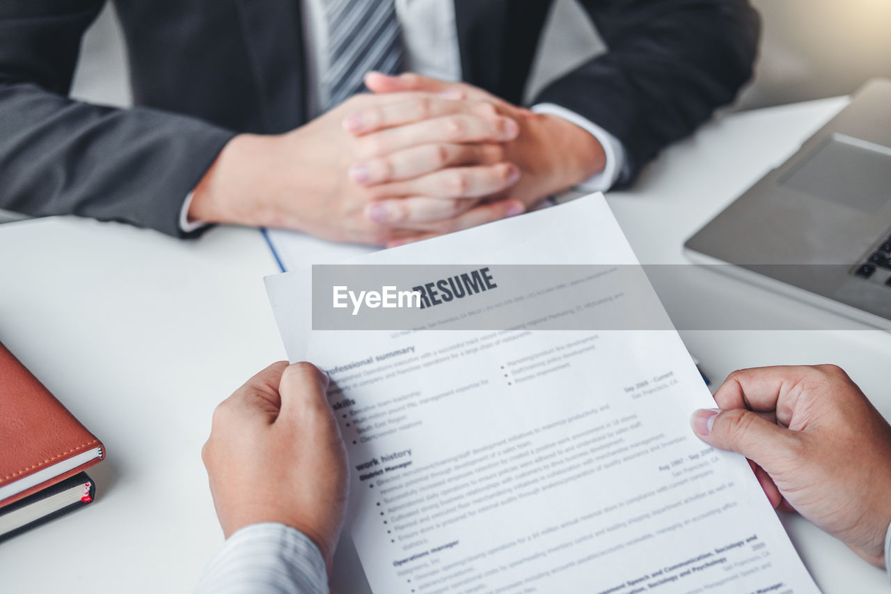 midsection of business colleagues working at desk in office