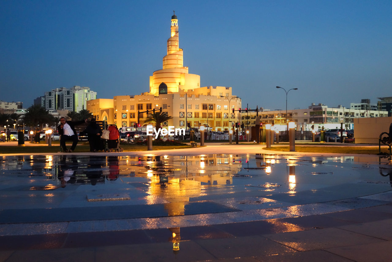 VIEW OF ILLUMINATED CITY AT NIGHT