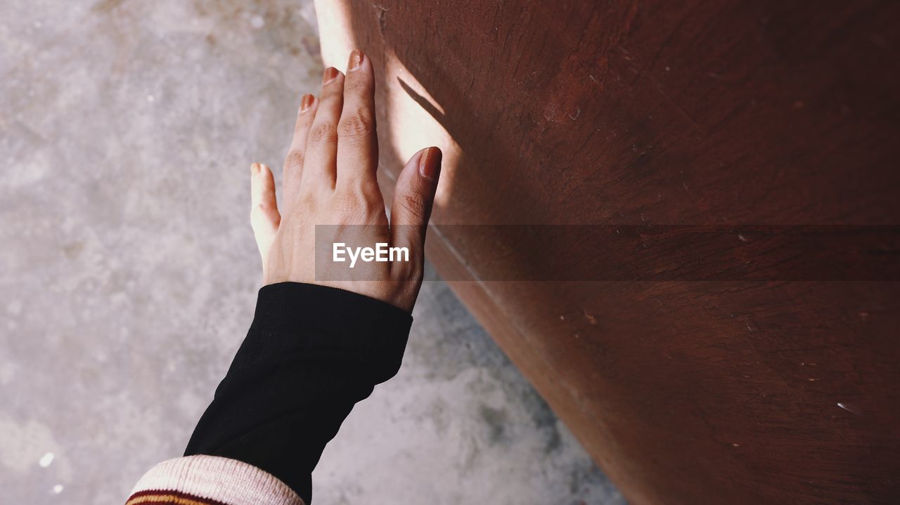 Close-up of hands against wall