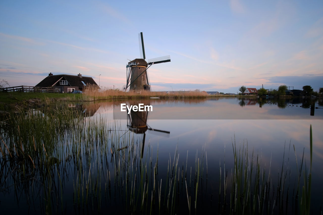 CRANES IN LAKE AGAINST SKY