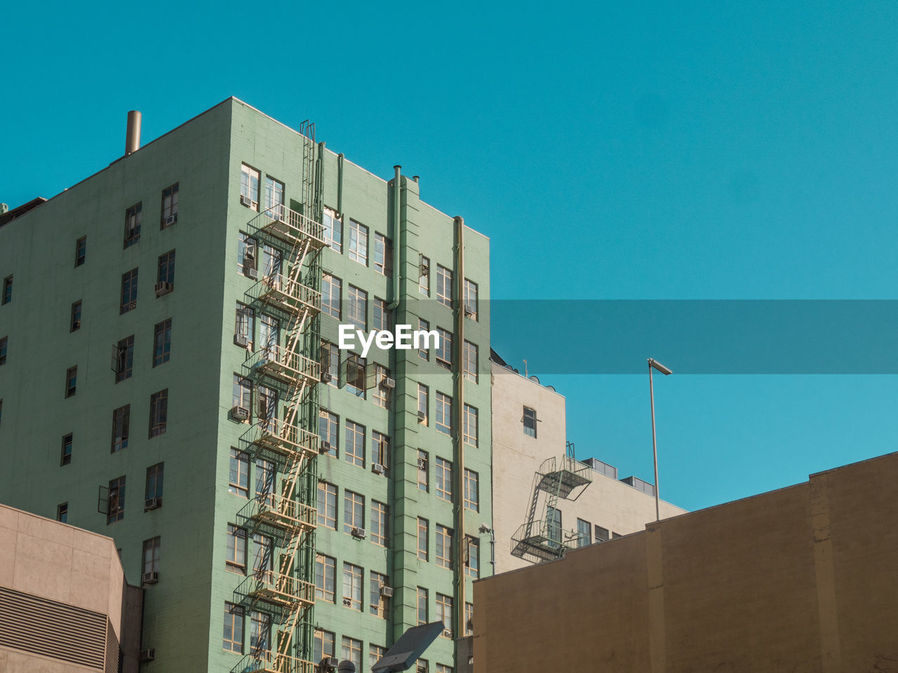 Low angle view of building against clear blue sky