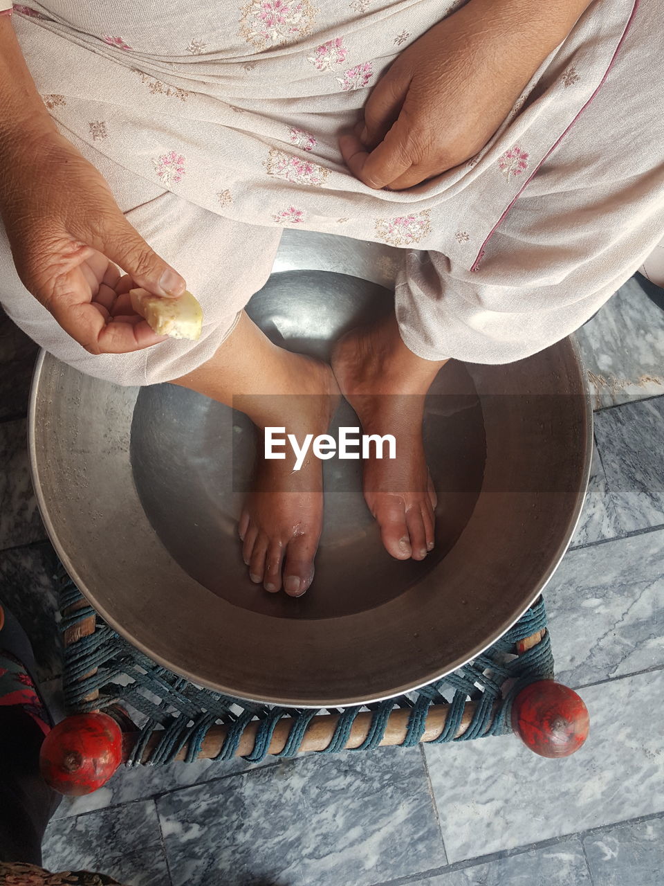 Low section of woman sitting on table